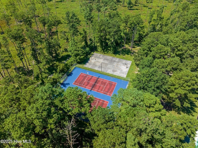 drone / aerial view with a wooded view