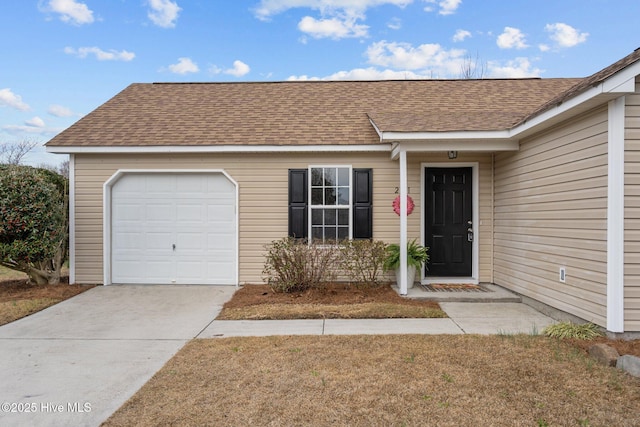 view of front of home featuring a garage, driveway, and a shingled roof