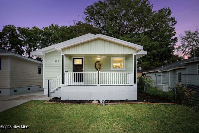 bungalow-style house with a porch and a yard