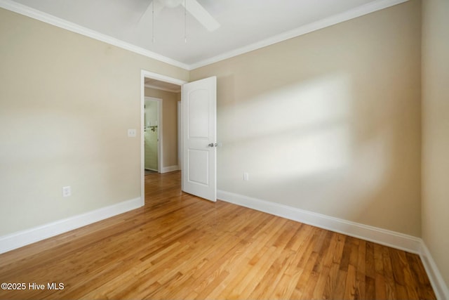 spare room featuring hardwood / wood-style flooring, ornamental molding, and ceiling fan