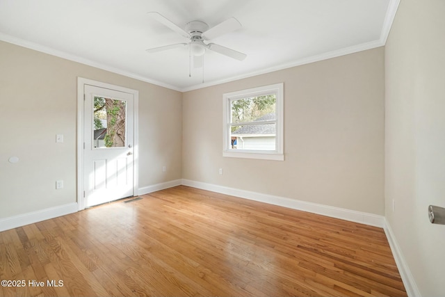 empty room featuring ceiling fan, ornamental molding, and light hardwood / wood-style flooring