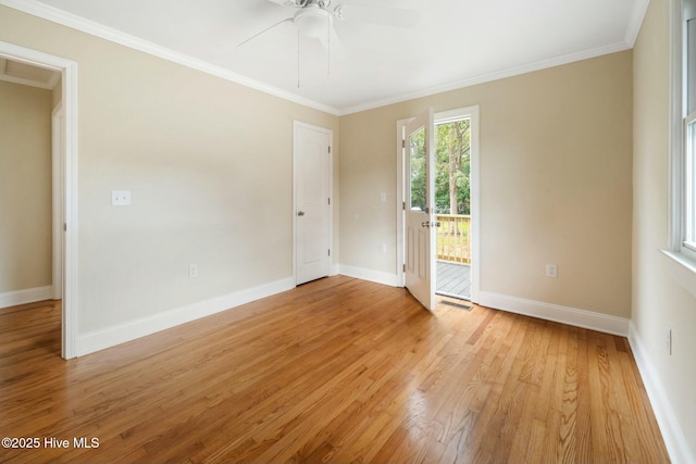 empty room with ornamental molding, ceiling fan, and light wood-type flooring