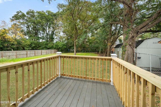 wooden terrace with a lawn