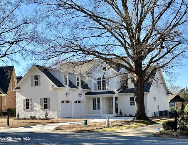 traditional-style home with stucco siding and concrete driveway