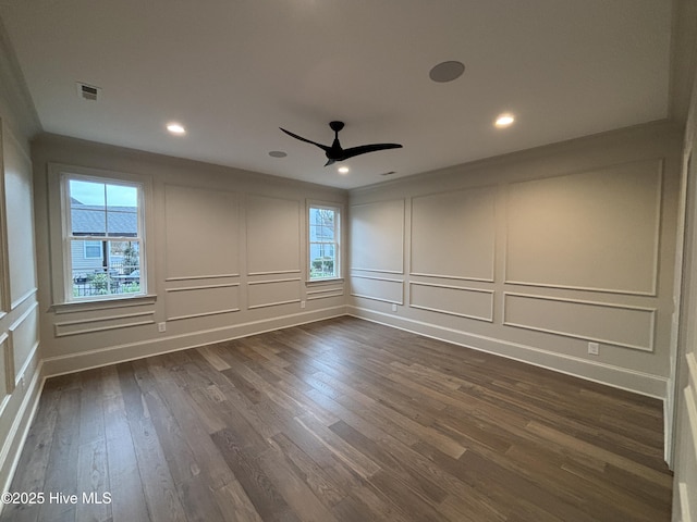 unfurnished room featuring visible vents, a ceiling fan, dark wood-style flooring, a decorative wall, and recessed lighting