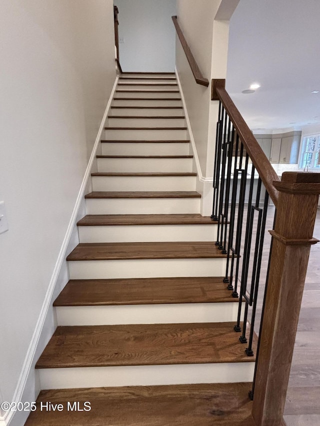 stairway featuring wood finished floors