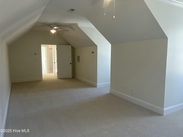 additional living space with ceiling fan, lofted ceiling, visible vents, and baseboards