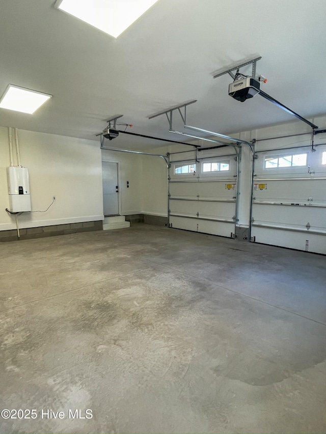 garage featuring water heater and a garage door opener