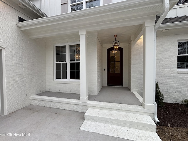 doorway to property with a porch and board and batten siding