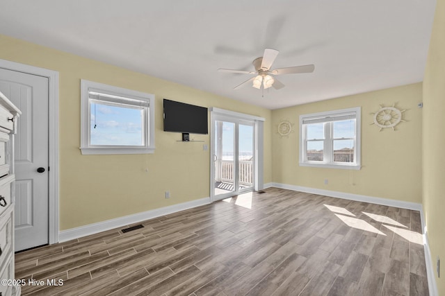 unfurnished room featuring ceiling fan and hardwood / wood-style floors