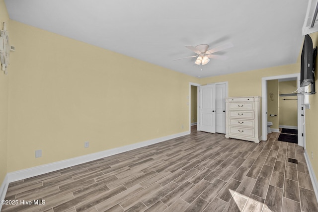 unfurnished bedroom featuring connected bathroom and ceiling fan