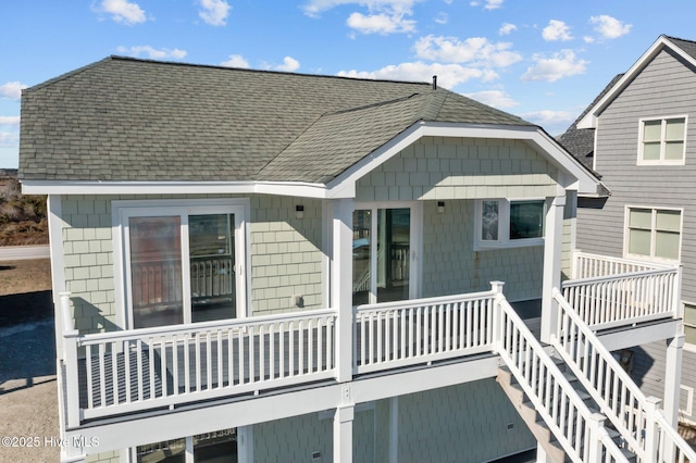 back of property featuring a balcony