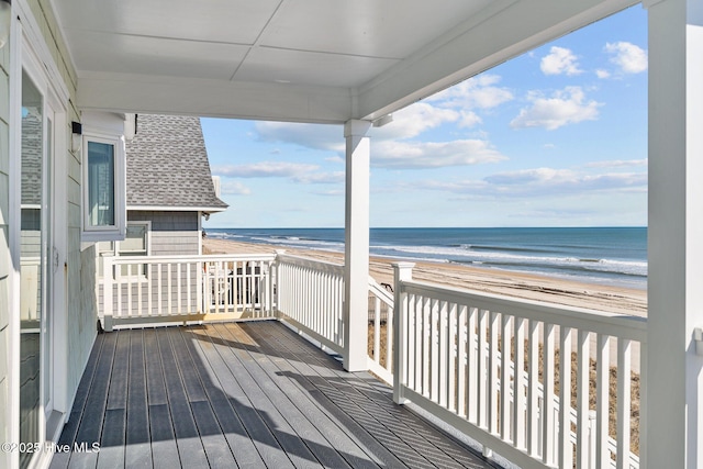 wooden terrace with a water view and a beach view