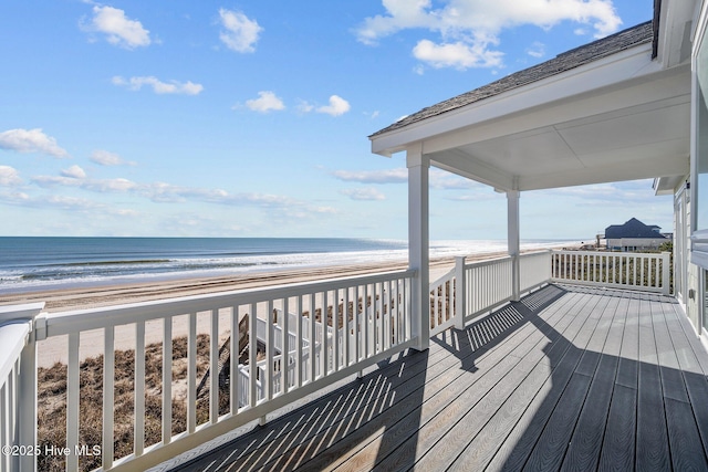 deck with a water view and a beach view