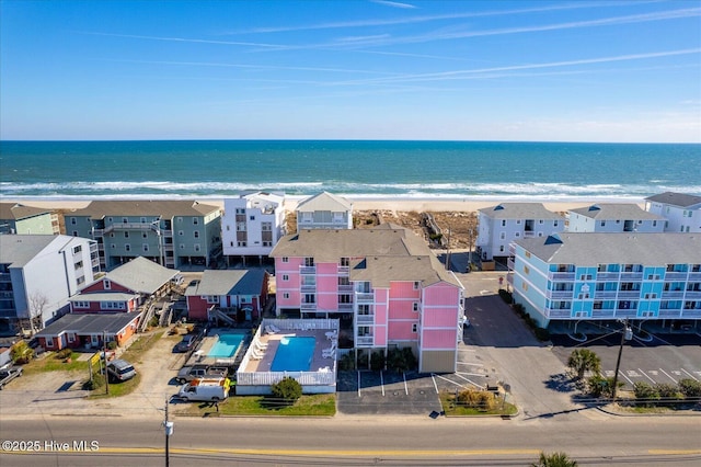 birds eye view of property with a water view and a view of the beach