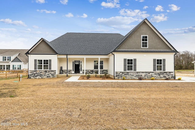 view of front of house with covered porch and a front lawn