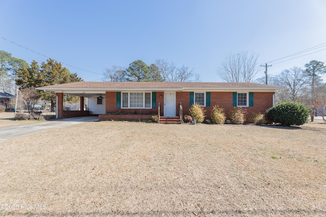 ranch-style home with a carport, concrete driveway, and brick siding