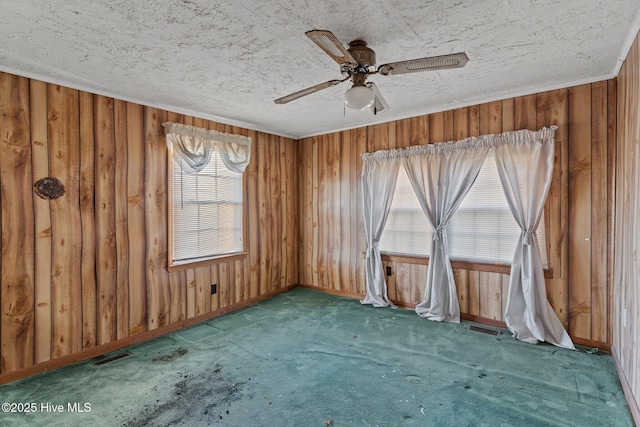 318 Locks No 1 Rd, Riegelwood, NC 28456 - carpeted spare room featuring a textured ceiling, crown molding, wooden walls, and ceiling fan