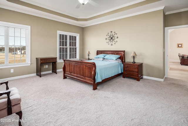 bedroom featuring light carpet, ornamental molding, a ceiling fan, and baseboards