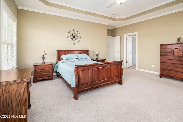 bedroom featuring ceiling fan, light colored carpet, baseboards, a tray ceiling, and crown molding