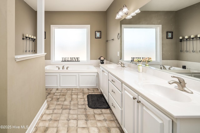 full bath with double vanity, a sink, and a bath