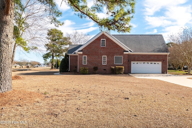 view of front facade featuring concrete driveway, brick siding, and an attached garage