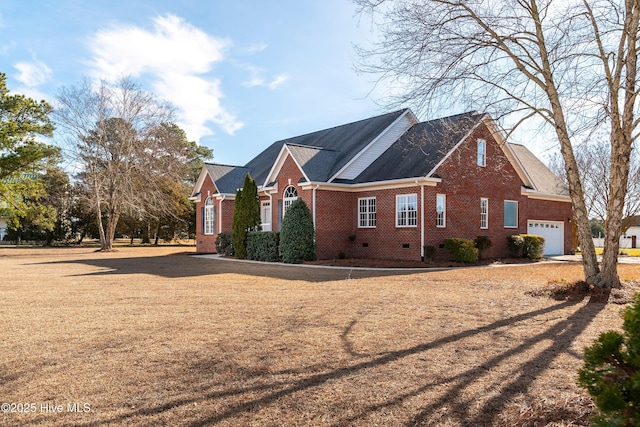 exterior space with a garage, crawl space, and brick siding