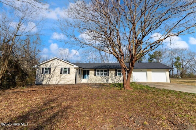 ranch-style house with driveway and an attached garage