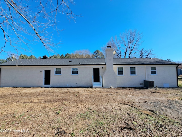 rear view of house with a yard and central air condition unit