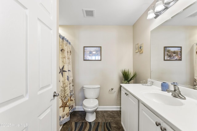 bathroom featuring vanity, tile patterned flooring, and toilet