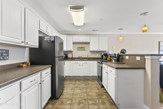 kitchen featuring sink, white cabinetry, stainless steel appliances, dark tile patterned flooring, and decorative light fixtures