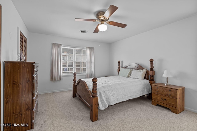 bedroom with baseboards, ceiling fan, visible vents, and light colored carpet