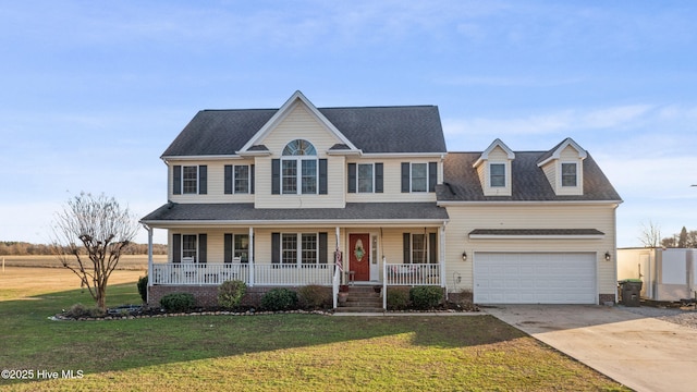 view of front facade featuring covered porch, a garage, and a front yard