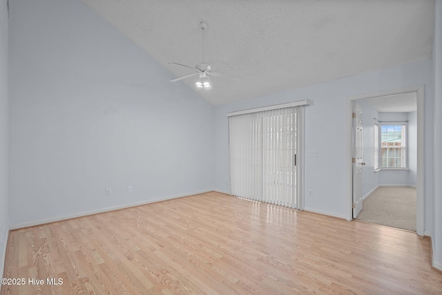 unfurnished bedroom featuring light hardwood / wood-style flooring, lofted ceiling, a textured ceiling, ceiling fan, and access to exterior