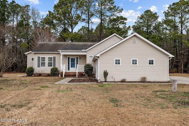 single story home with a front yard and covered porch