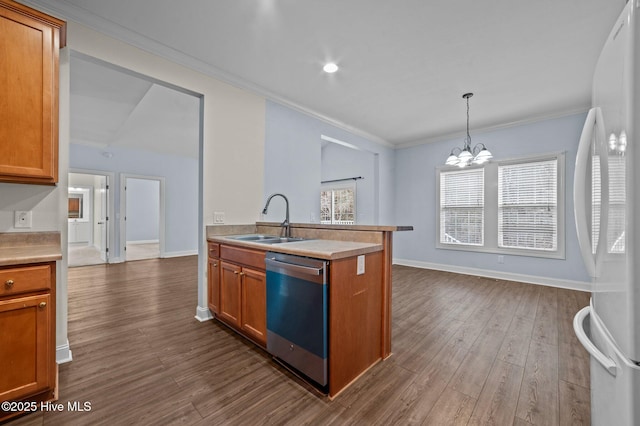 kitchen with dark wood-type flooring, sink, hanging light fixtures, white refrigerator, and stainless steel dishwasher