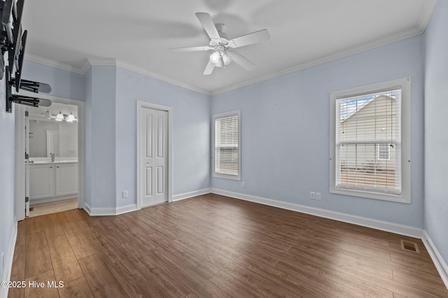 225 Adams Ln, Washington, NC 27889 - unfurnished bedroom featuring multiple windows, dark wood-style floors, baseboards, and ornamental molding