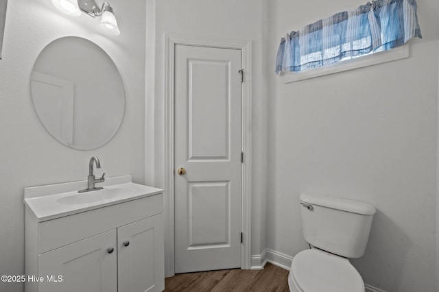 bathroom with vanity, hardwood / wood-style floors, and toilet