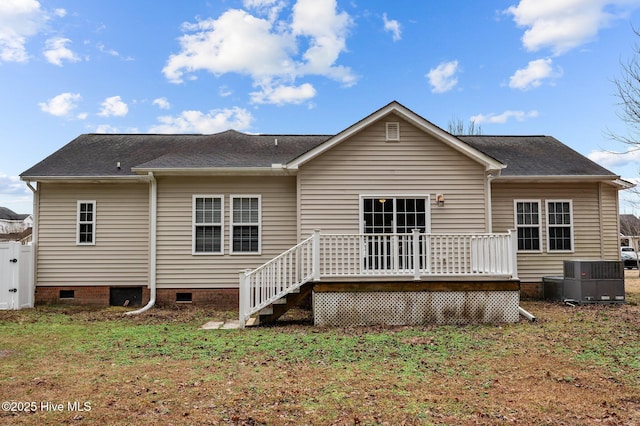 back of property featuring a deck, a lawn, and central air condition unit