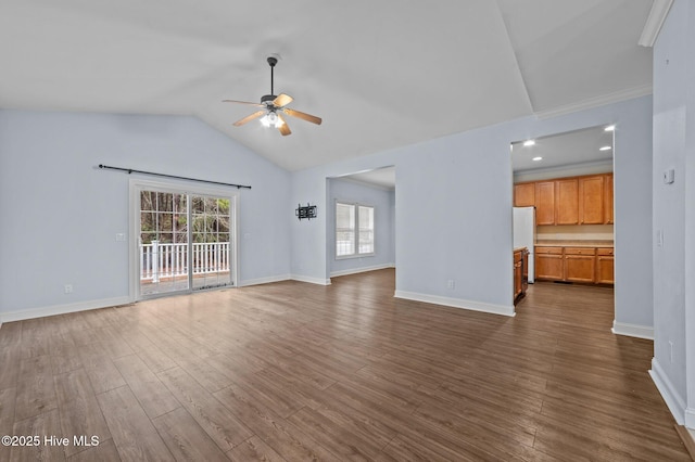 unfurnished living room featuring lofted ceiling, dark hardwood / wood-style floors, and ceiling fan