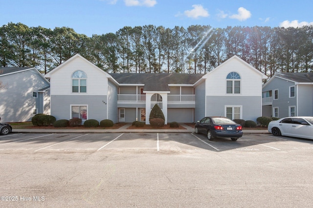 view of building exterior with uncovered parking