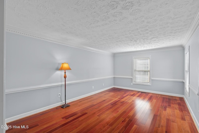 spare room with crown molding, a textured ceiling, and hardwood / wood-style floors