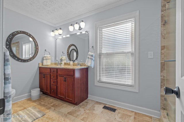 bathroom featuring vanity, a textured ceiling, and ornamental molding