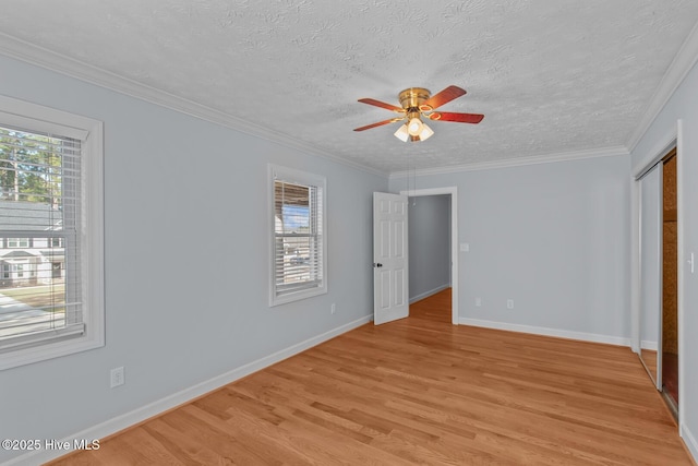 unfurnished bedroom with a textured ceiling, crown molding, ceiling fan, and light hardwood / wood-style flooring