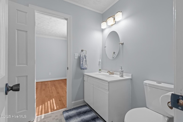 bathroom with toilet, wood-type flooring, a textured ceiling, vanity, and crown molding