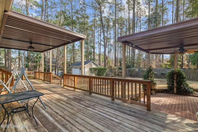 deck featuring a shed and ceiling fan