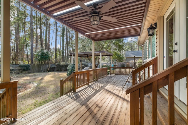 wooden terrace featuring a gazebo and ceiling fan