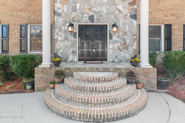 view of exterior entry featuring covered porch