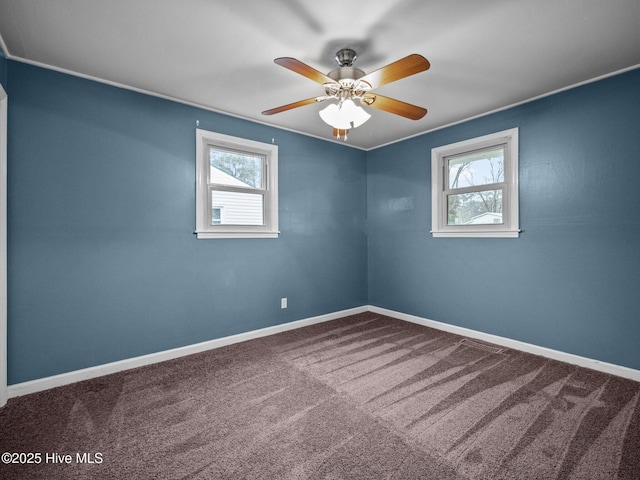 unfurnished room featuring a wealth of natural light, carpet floors, and baseboards