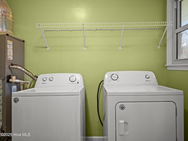 washroom with washer and clothes dryer, water heater, and laundry area